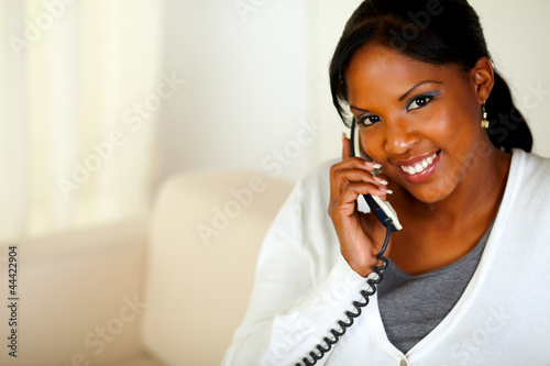 Smiling black woman looking at you while talking