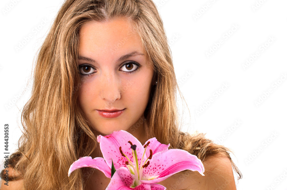 Beautiful young woman holding a white lily at face Beautiful young woman holding a white lily at face