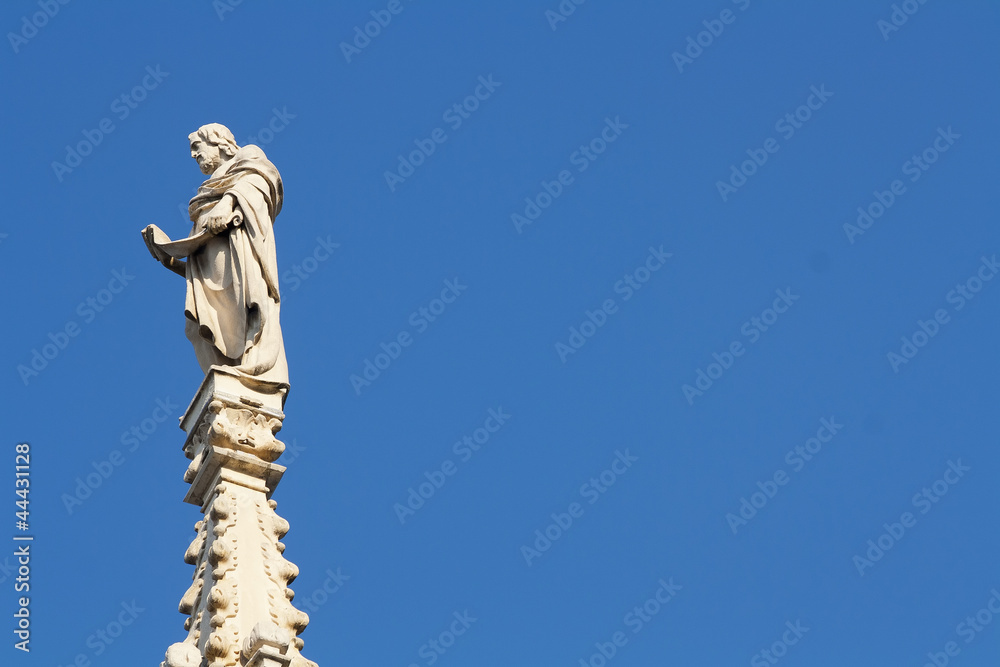 Fototapeta premium Ancient marble statue over the Milan cathedral