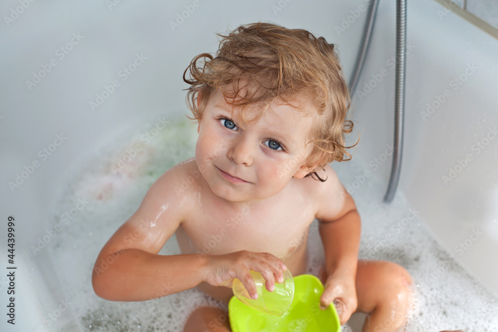 Adorable toddler with blond hairs taking bath Adorable toddler with blond hairs taking bath