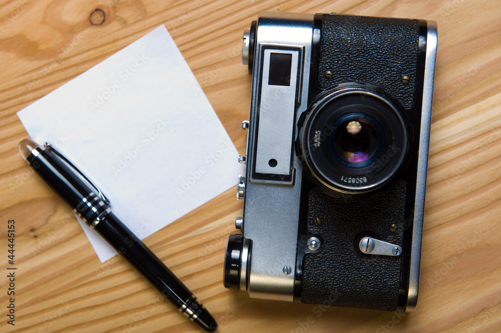 old rangefinder camera with memo and pen