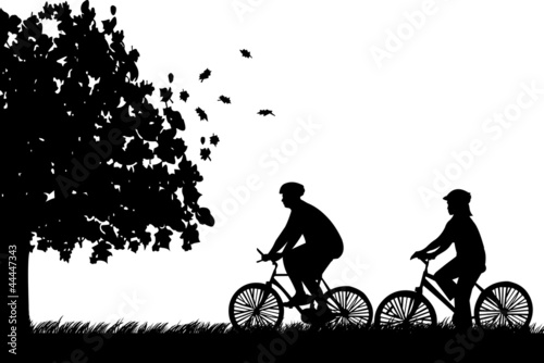 Fototapeta Naklejka Na Ścianę i Meble -  Couple bike ride in park in autumn or fall silhouette