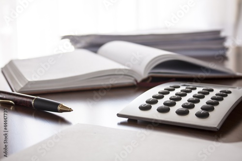 planner with  pen and calculator on the table
