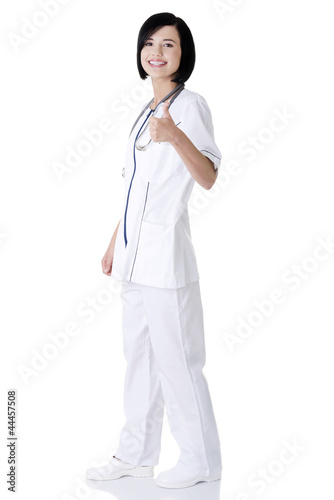 Young female doctor or nurse gesturing OK