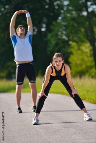 Couple doing stretching exercise after jogging