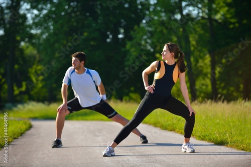 Couple doing stretching exercise after jogging