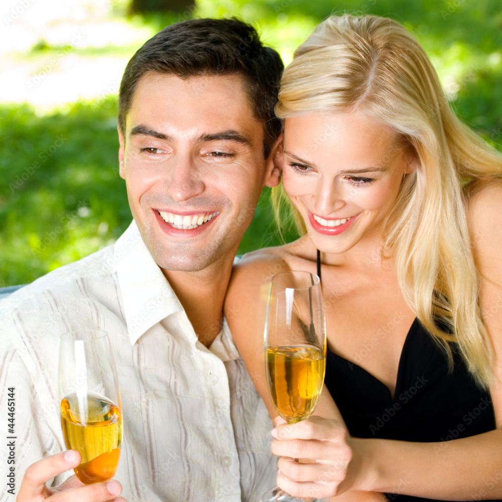 Young happy couple with champagne, outdoor