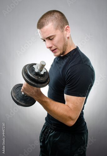 Sportsman lifting a dumbbell
