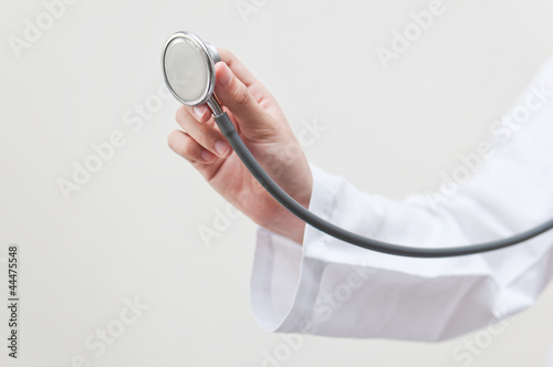 Hand holding stethoscope photo