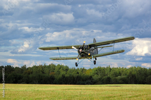 Fotografie, Obraz Historic airborne biplane landing at airfield.