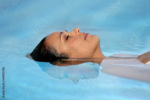 Woman with her eyes closed in a swimming pool photo