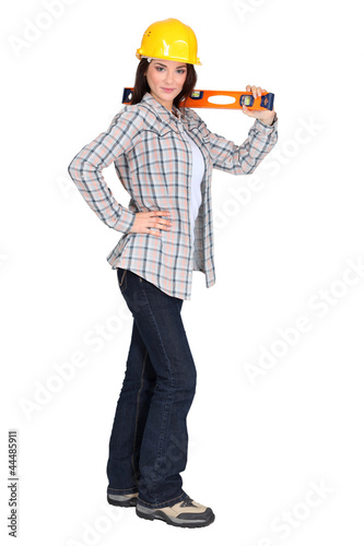 Attractive brunette holding spirit-level photo