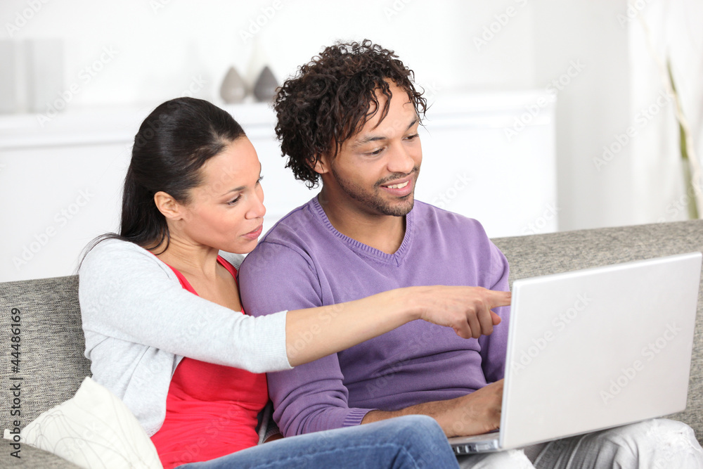 Metis couple using laptop at home Metis couple using laptop at home