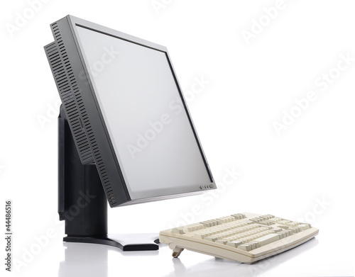 LCD monitor with old classic keyboard on white background