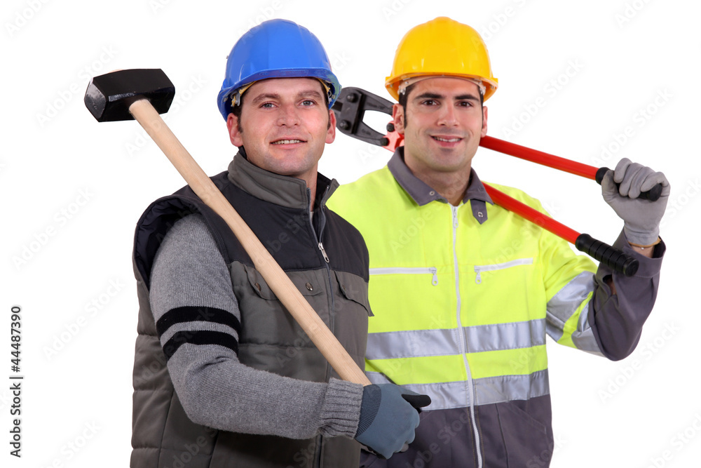 Two workers with tongs and shoulder harness Two workers with tongs and shoulder harness