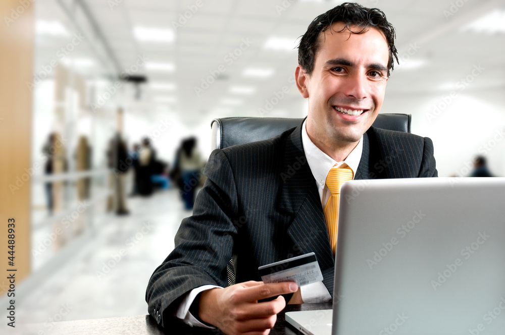 e-commerce concept: business man paying online with his credit c e-commerce concept: business man paying online with his credit c