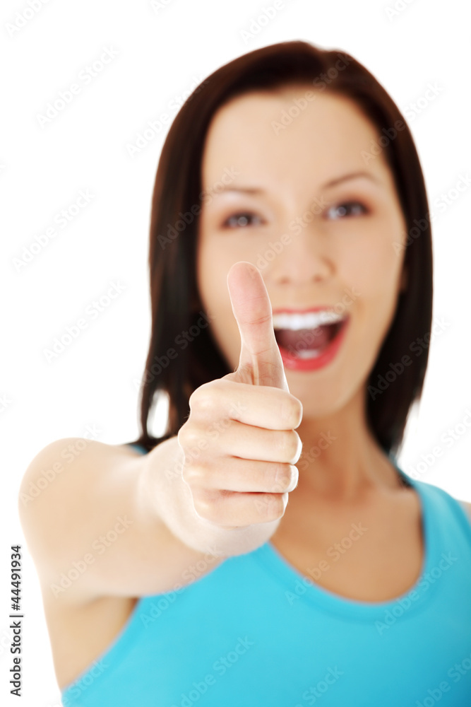 Beautiful young woman showing thumbs up sign Beautiful young woman showing thumbs up sign