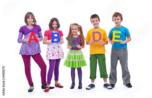 Young school children holding A B C letters