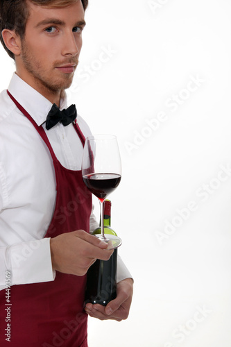 Sommelier serving a bottle of wine