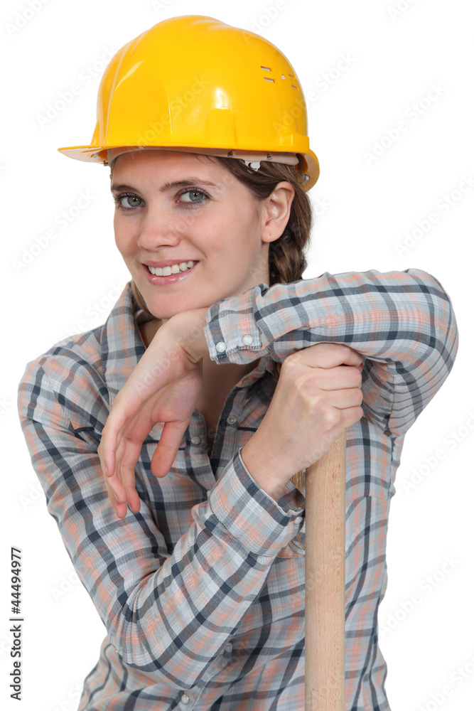 portrait of craftswoman with arm resting on hammer portrait of craftswoman with arm resting on hammer