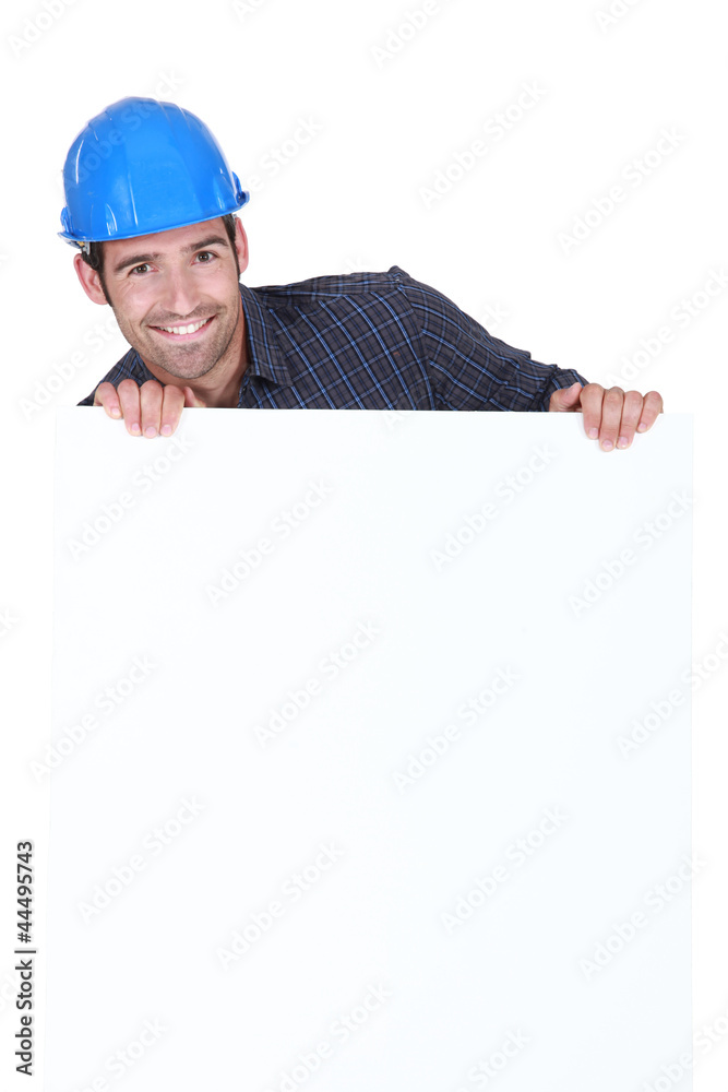 Manual worker stood with advertisement board Manual worker stood with advertisement board