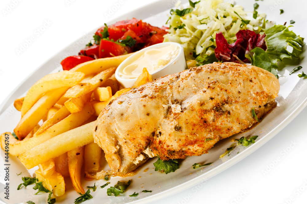 Grilled chicken breast, French fries and vegetables Grilled chicken breast, French fries and vegetables