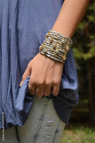 leather bracelet with rhinestones on the arm of a young girl