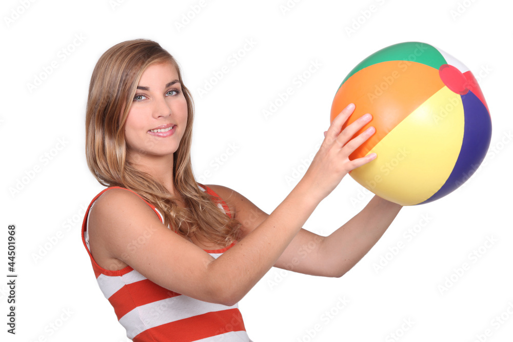 young woman holding a beach ball
