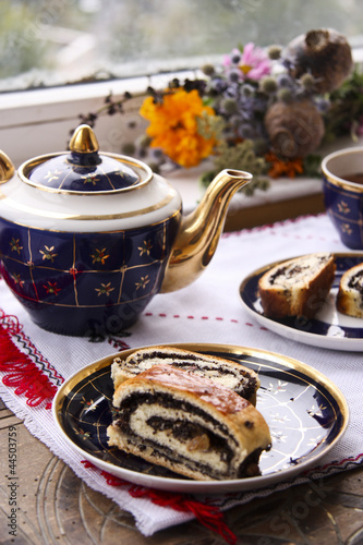 Tea and roll with poppy seeds