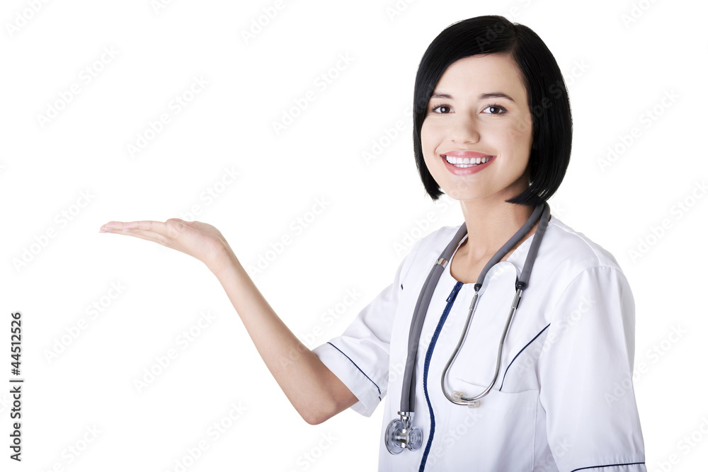 Young medical doctor woman presenting and showing copy space Young medical doctor woman presenting and showing copy space