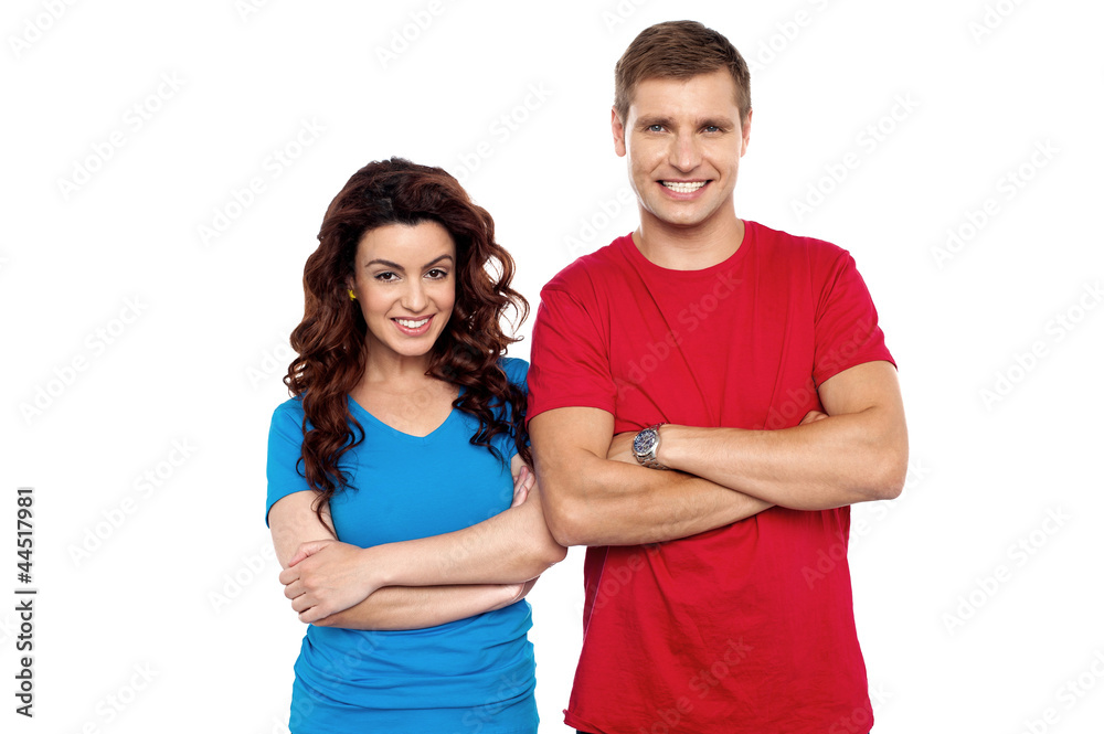 Attractive couple posing with arms crossed Attractive couple posing with arms crossed