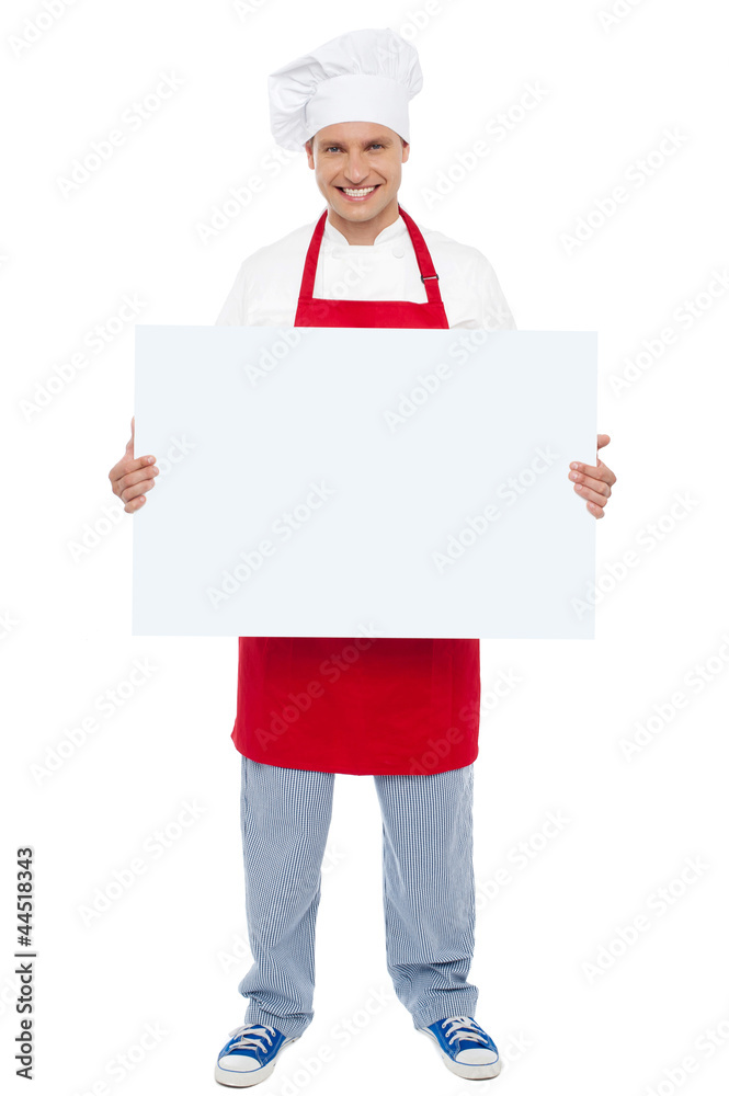 Chef holding blank white billboard. Full length shot Chef holding blank white billboard. Full length shot