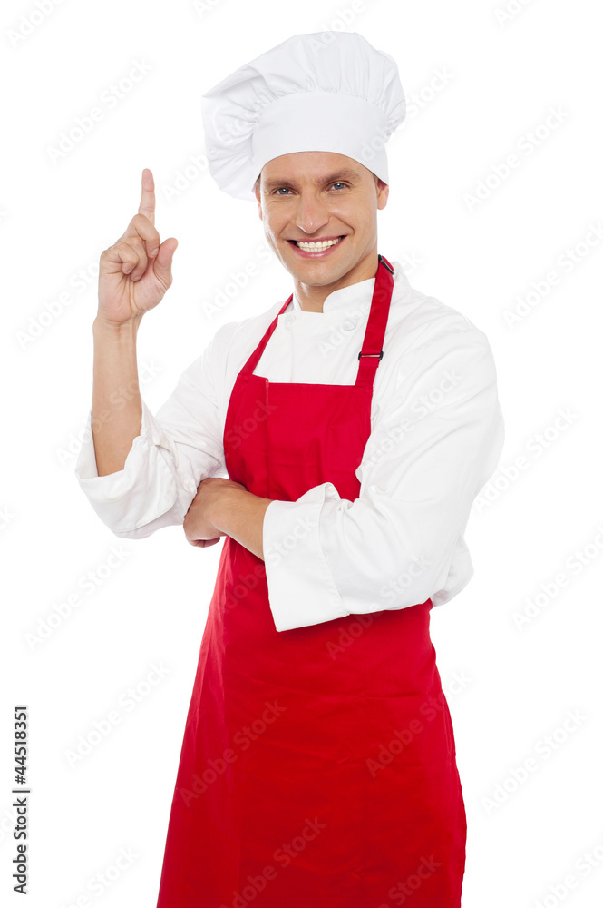 Happy smiling chef showing index finger Happy smiling chef showing index finger