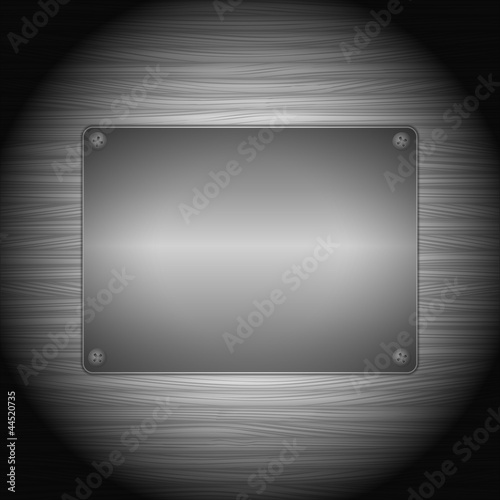 Metal board on wood background
