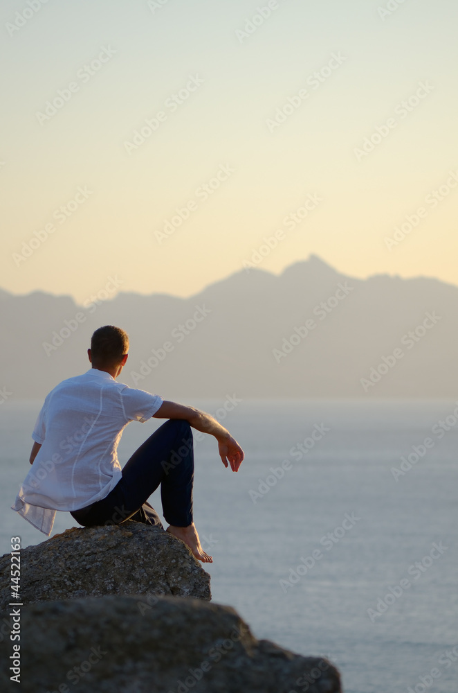 Man sits on a stone