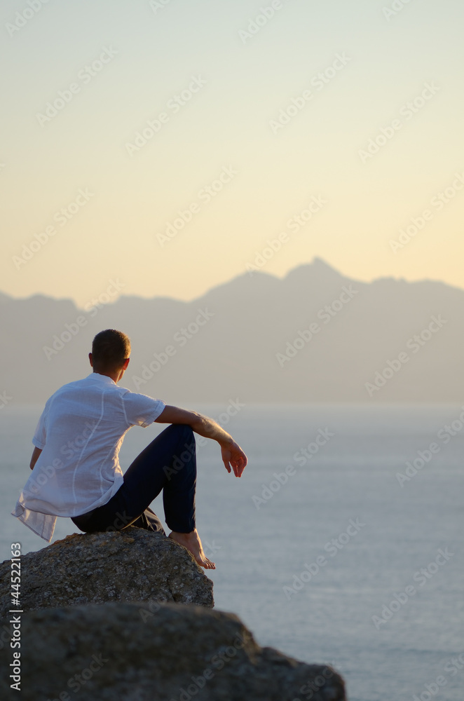 Man sits on a stone Man sits on a stone