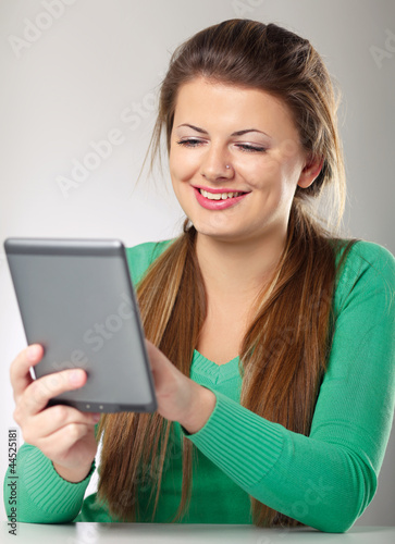 Young woman sitting and holding computer plane-table