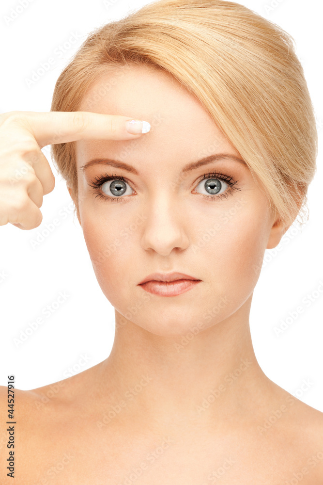 beautiful woman pointing to forehead