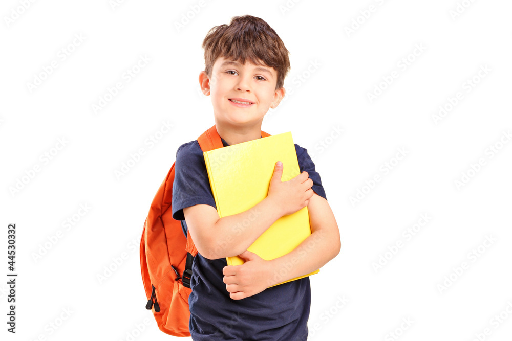 A school boy with backpack holding a notebook A school boy with backpack holding a notebook