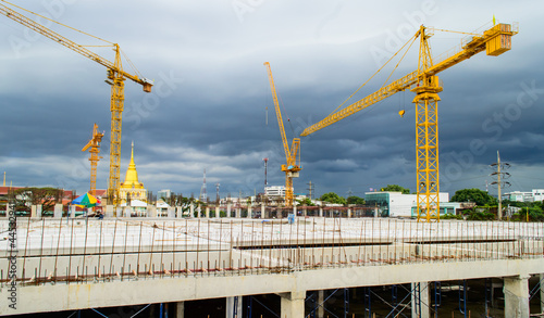 Construction site with crane near building on Cloudy storm backg