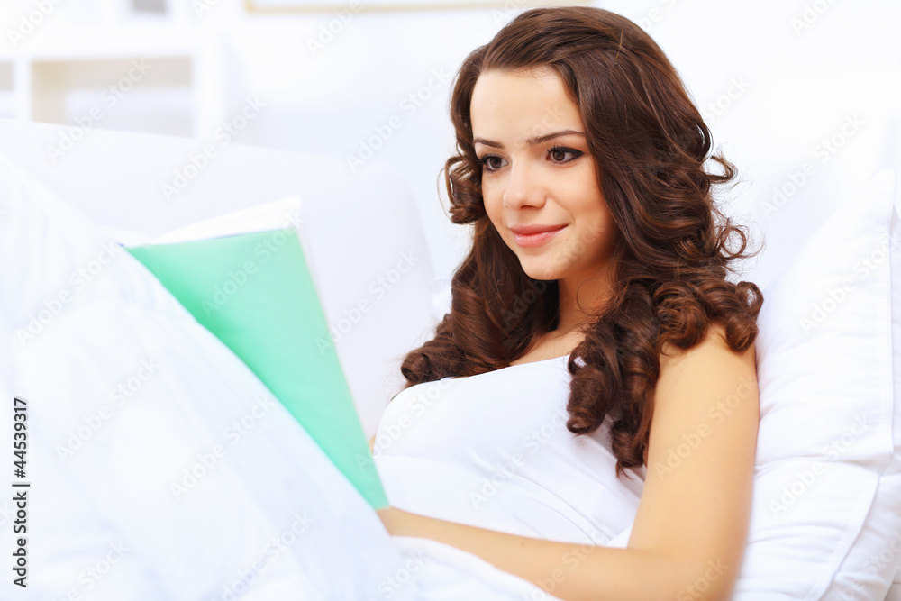 Young woman at home with a book Young woman at home with a book