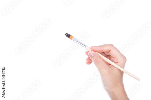 Woman hand with paintbrush isolated on white background