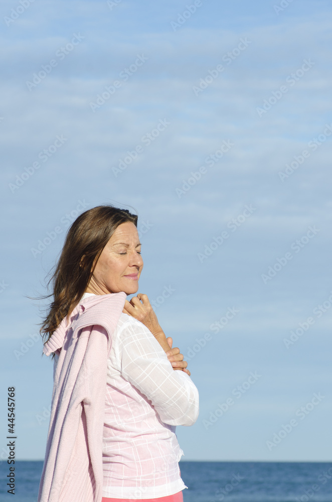 Beautiful relaxed senior woman ocean background Beautiful relaxed senior woman ocean background