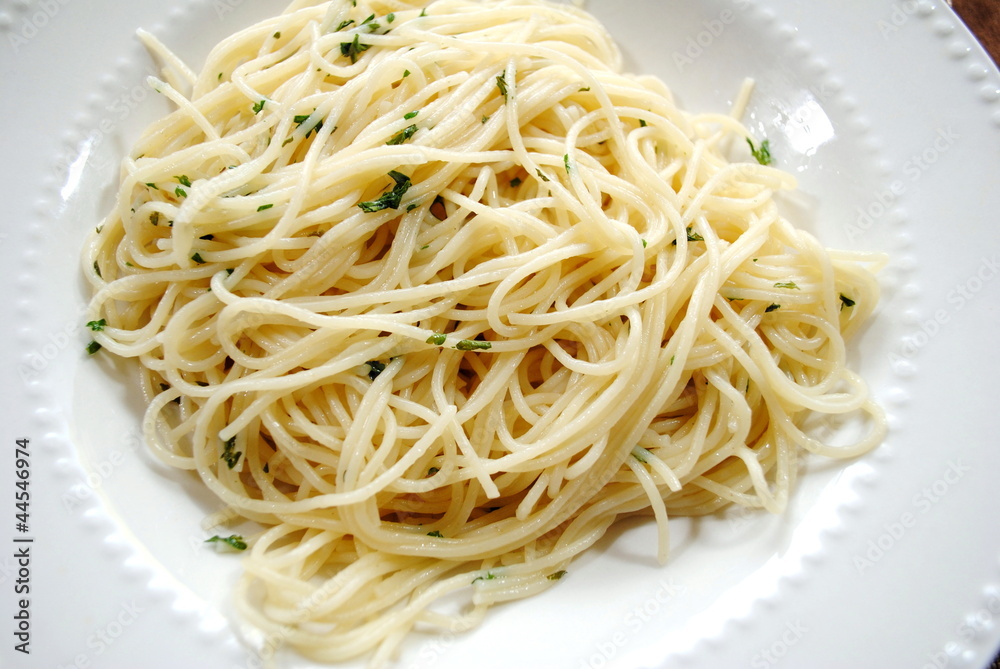 Spaghetti with Butter and Parsley on a White Plate Spaghetti with Butter and Parsley on a White Plate