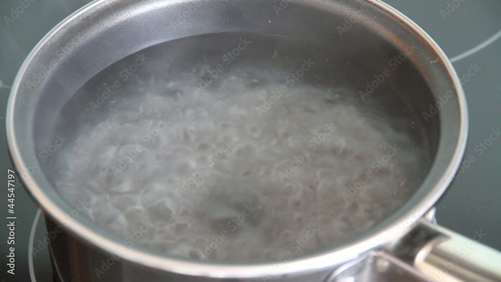 Steam of boiling water on stove in kitchen Steam of boiling water on stove in kitchen