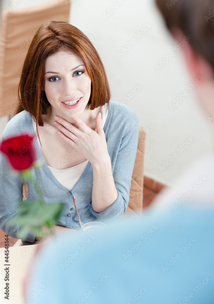 Man presents a crimson rose to his girlfriend Man presents a crimson rose to his girlfriend