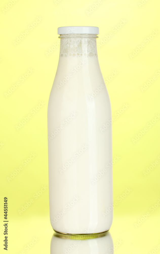bottle of milk on yellow background close-up bottle of milk on yellow background close-up