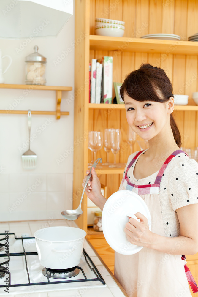 Beautiful young woman in the kitchen. Portrait of asian. Beautiful young woman in the kitchen. Portrait of asian.