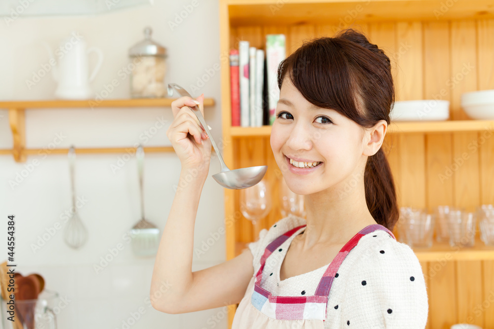 Beautiful young woman in the kitchen. Portrait of asian. Beautiful young woman in the kitchen. Portrait of asian.