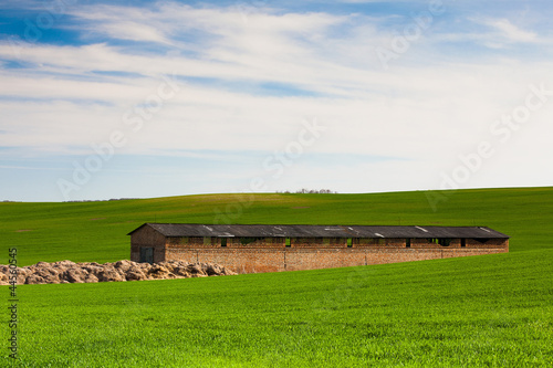 Old Stone Barn on the barley field in Moravia photo